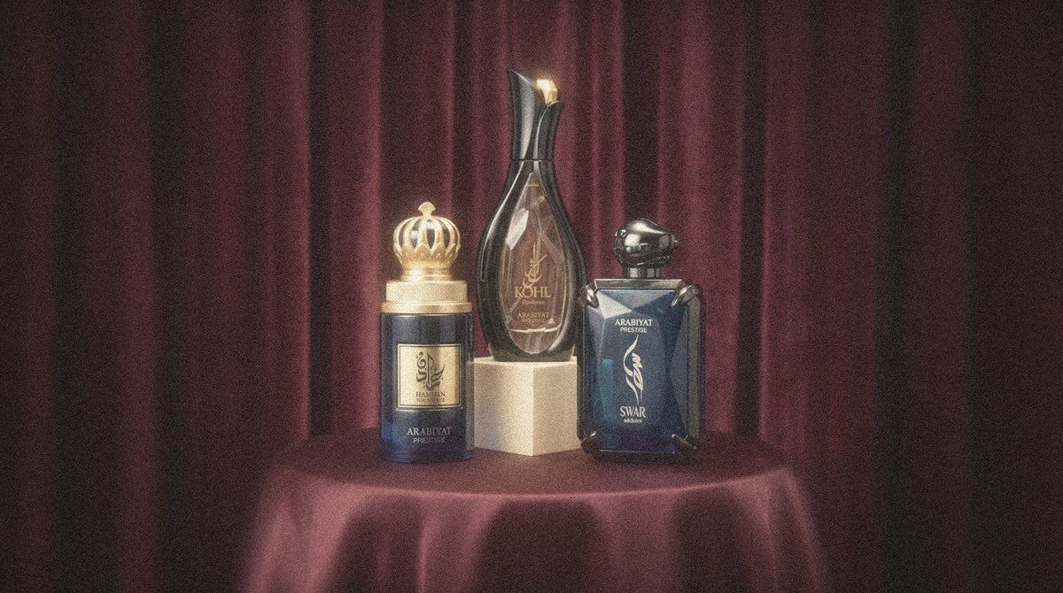 Arabiyat Prestige Kohl Opulence, Hamdan and Swar Seduire on a draped pedestal before a burgundy velvet curtain