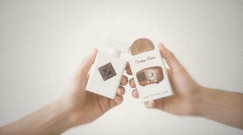 Two hands holding Initio Paragon and Lattafa Vintage Radio together
