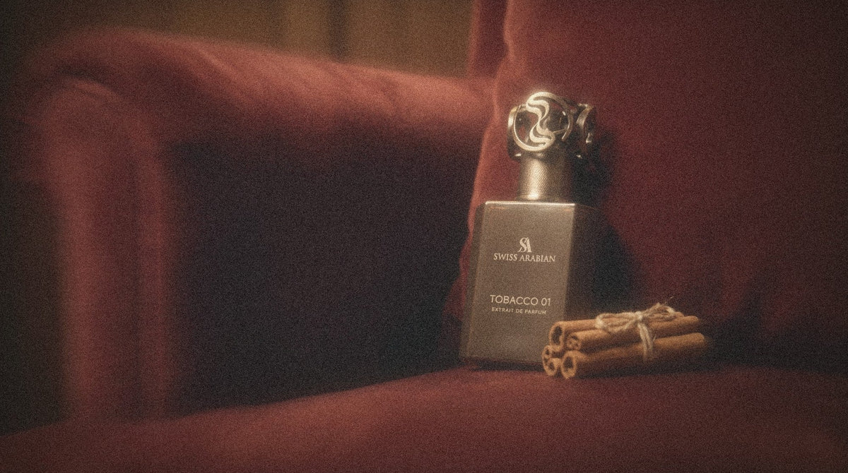 Swiss Arabian Tobacco 01 on an oxblood velvet armchair with cinnamon sticks